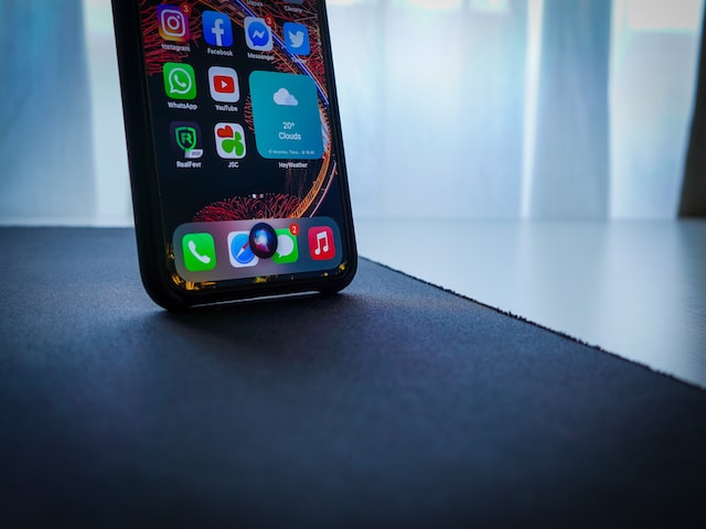 black iphone on black table