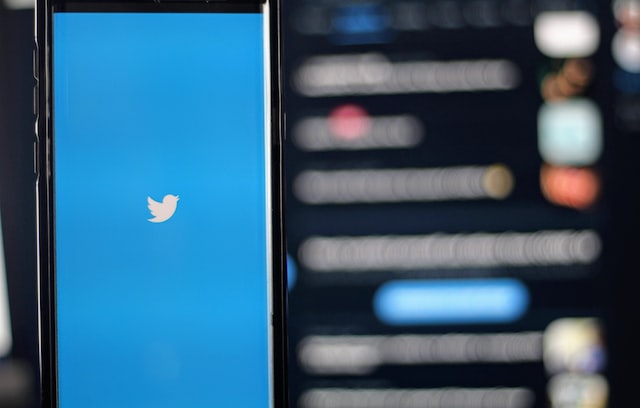 white iphone displaying twitter logo