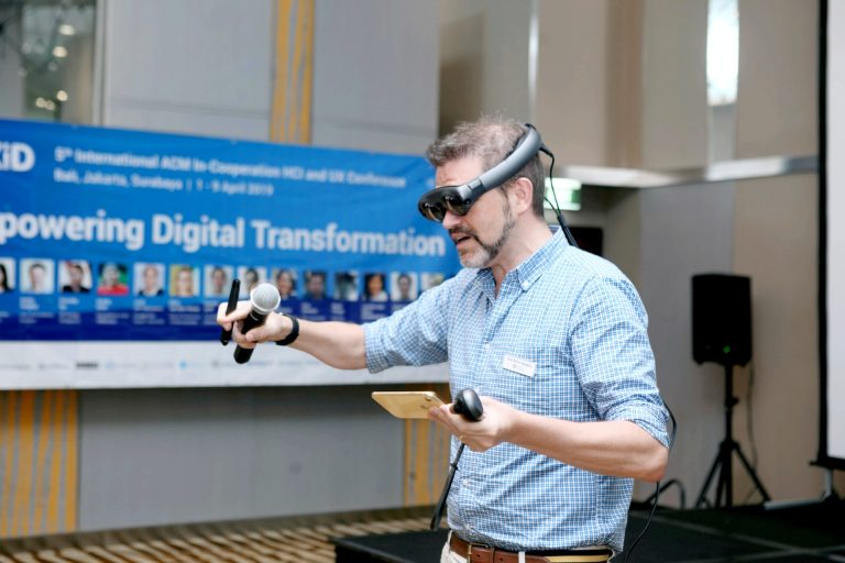 man wearing virtual reality glasses at a conference