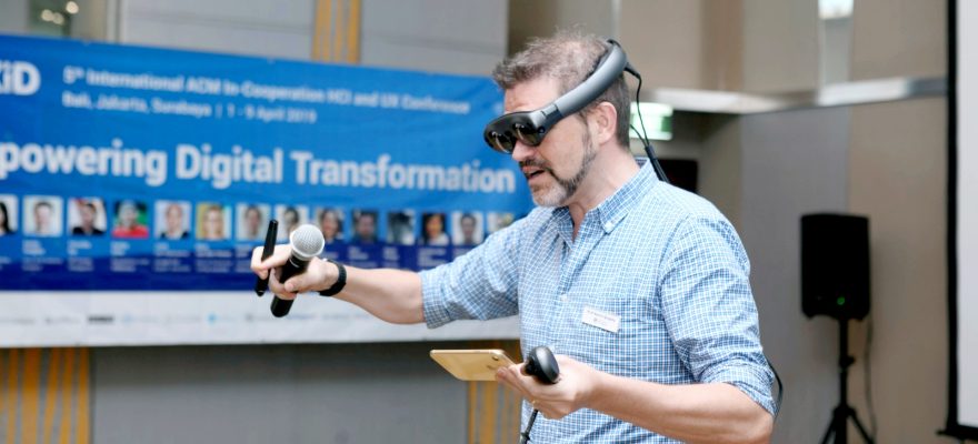 man wearing virtual reality glasses at a conference