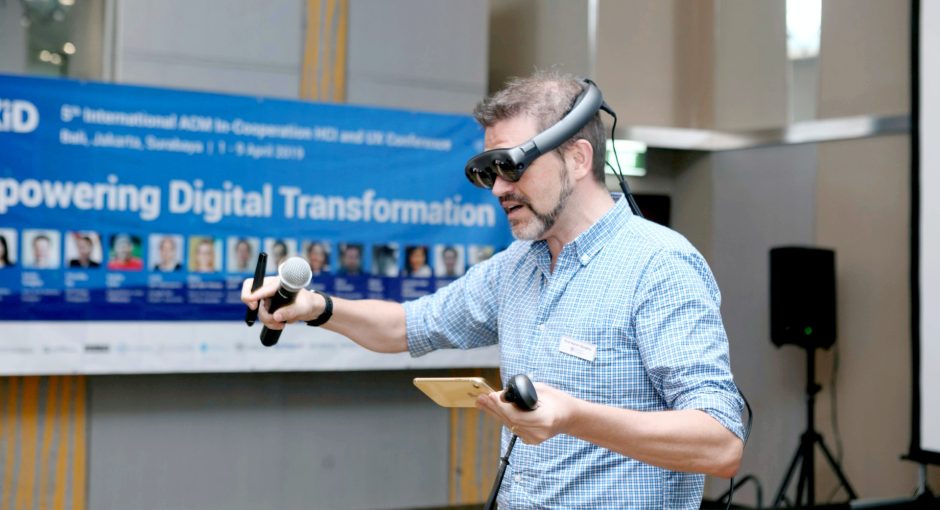 man wearing virtual reality glasses at a conference