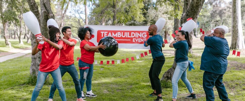 people-holding-toy-bowling-pins-and-playing-a-game