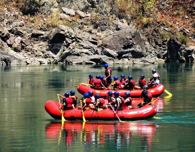 people-riding-on-red-kayak-on-river-during-daytime